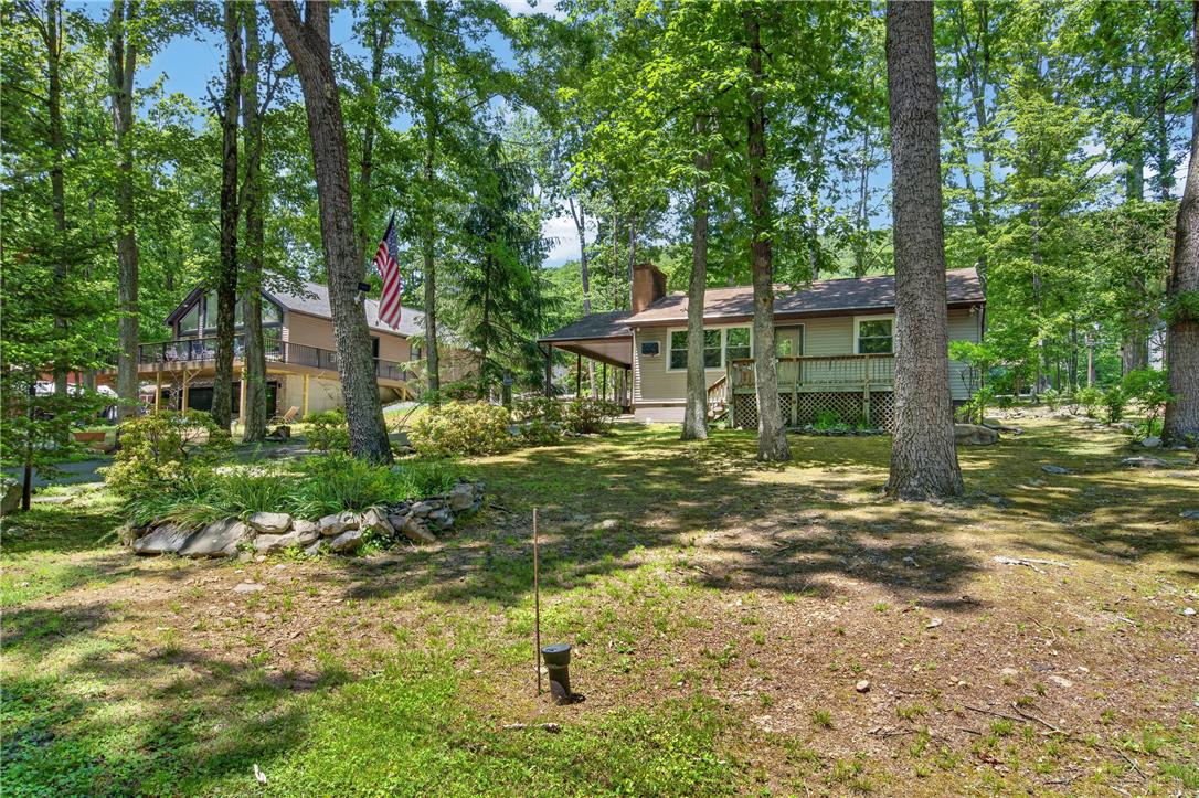 18 White Oak Road Nesquehoning, PA 18240 - Photo 41 of 52 A tranquil wooded setting surrounds two inviting residential structures with ample outdoor deck space.