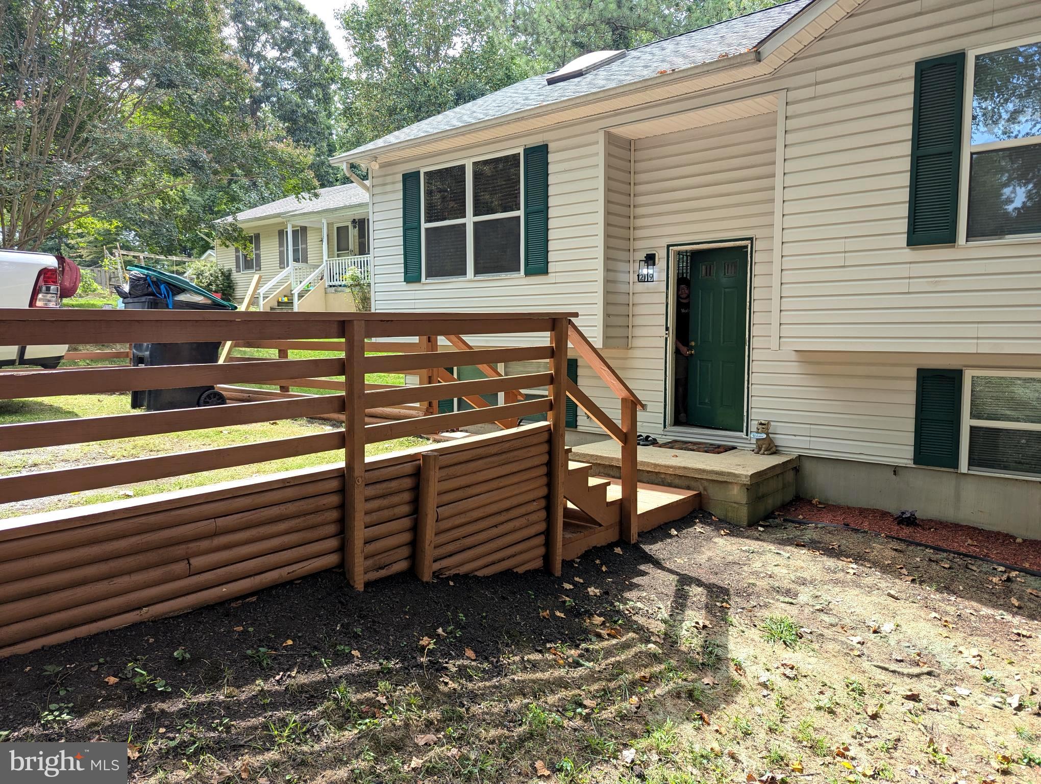 12119 Gringo Road Lusby, MD 20657 - Photo 2 of 20 a view of a house with a yard and wooden floor