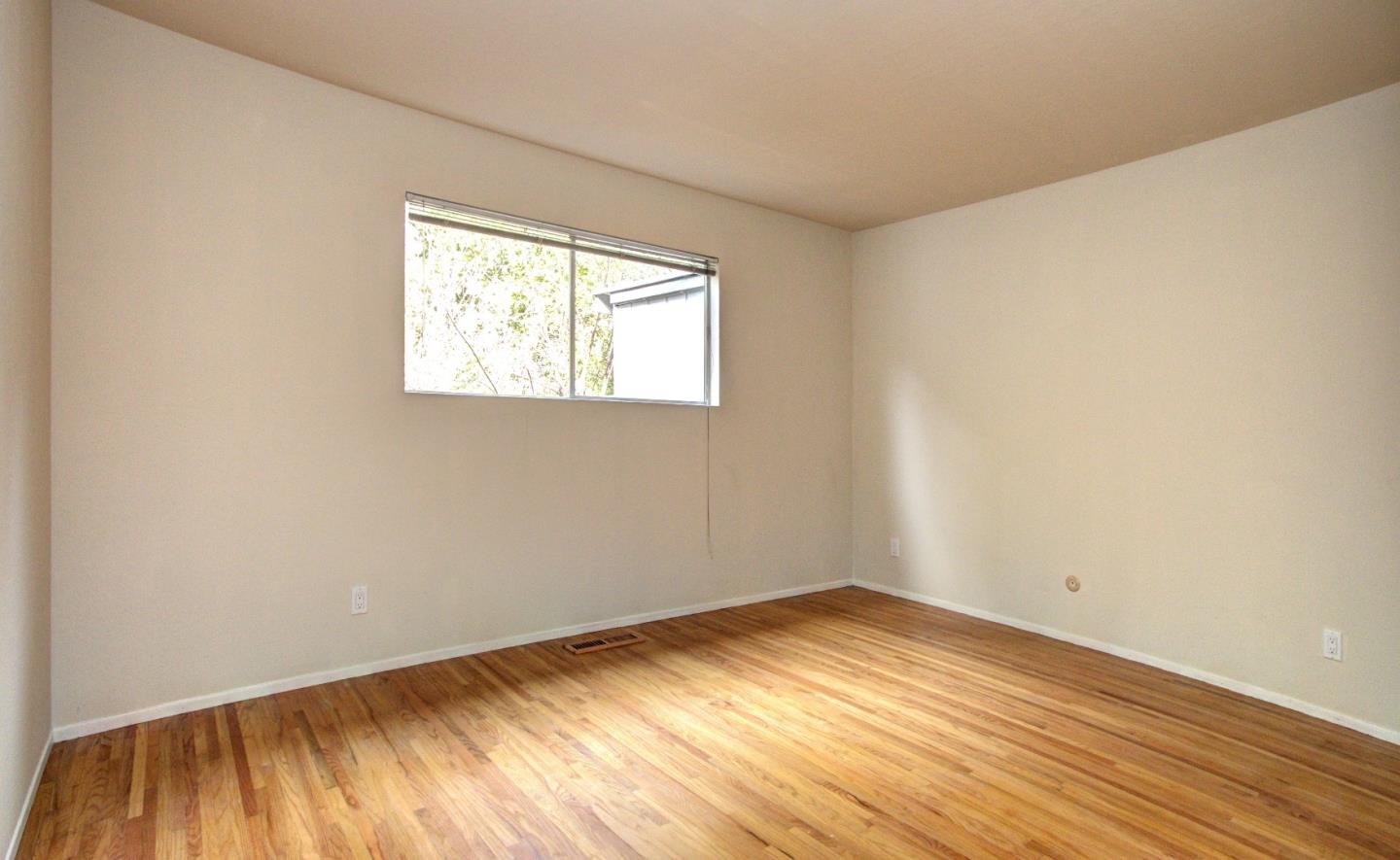 115 Estates Drive Ben Lomond, CA 95005 - Photo 8 of 13 an empty room with wooden floor and windows