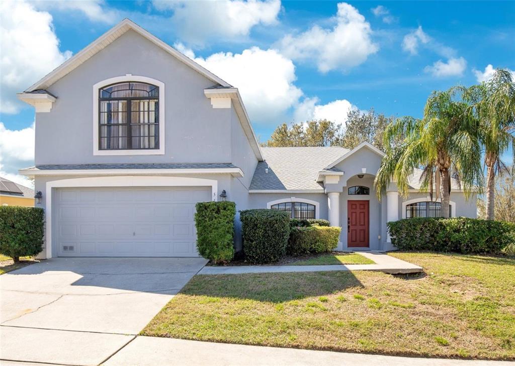 a front view of a house with a yard and garage