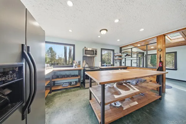 a kitchen with a large window and a sink