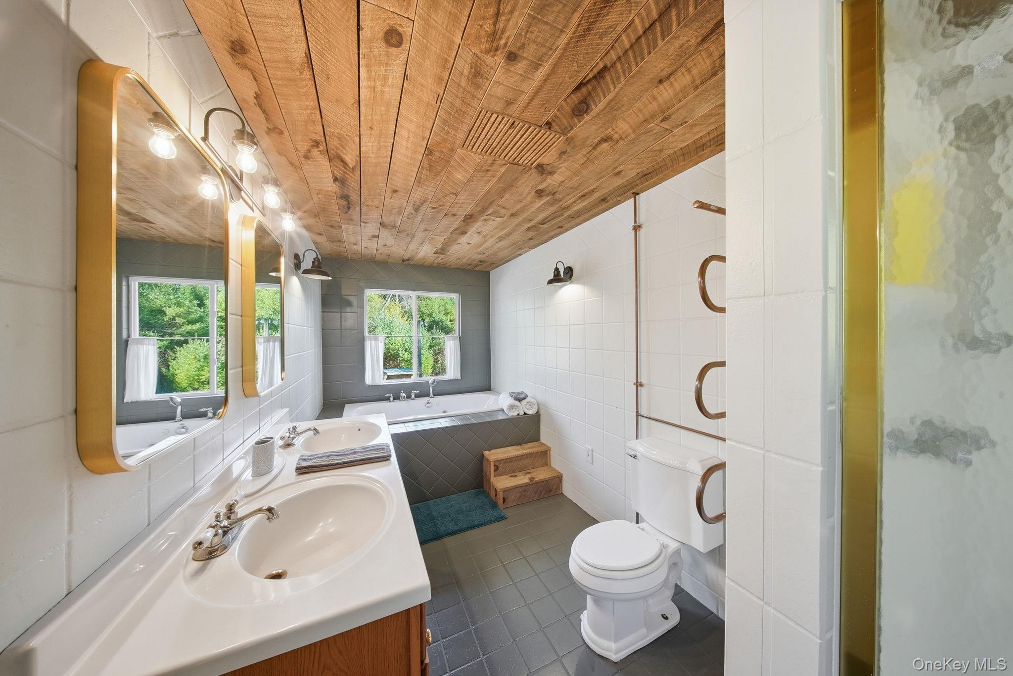 136 Barryville - Yulan Road Barryville, NY 12719 - Photo 23 of 37 Full bath featuring wood ceiling, vanity, tile walls, dark tile patterned flooring, and a bath