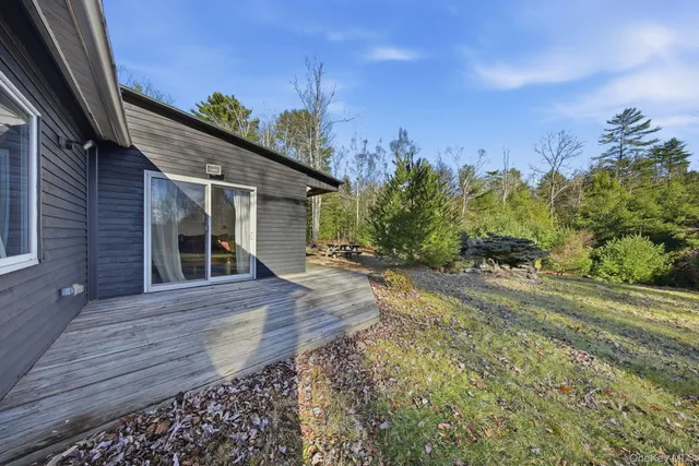 a view of house with swimming pool yard and outdoor seating
