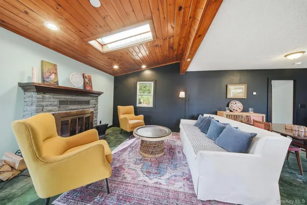 a living room with furniture and fireplace