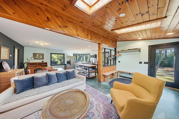 a view of a dining room with furniture large windows and wooden floor