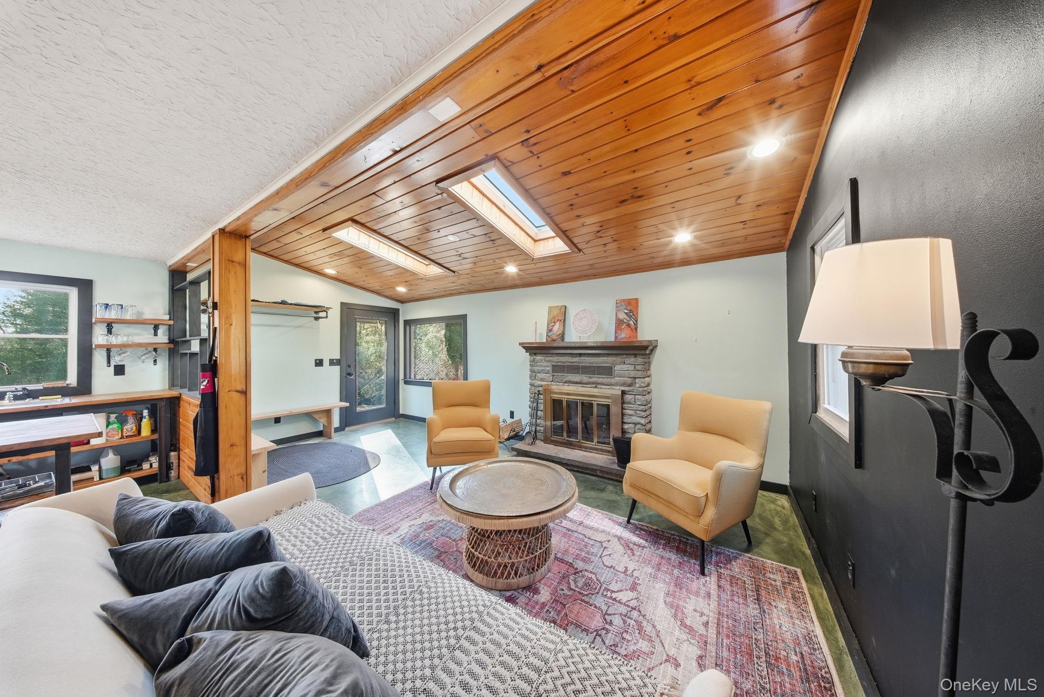 136 Barryville - Yulan Road Barryville, NY 12719 - Photo 8 of 37 Living room with lofted ceiling, wood ceiling, recessed lighting, a skylight, and a fireplace