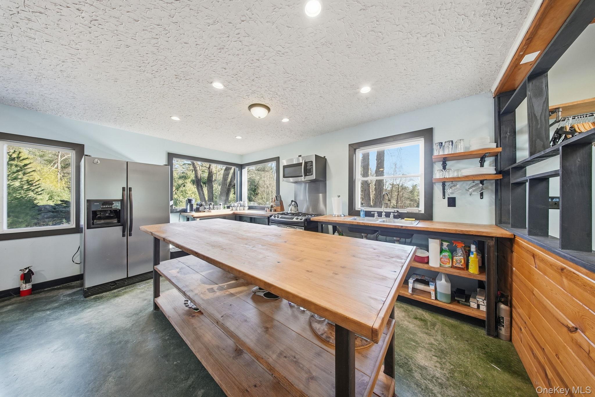 136 Barryville - Yulan Road Barryville, NY 12719 - Photo 10 of 37 Kitchen featuring appliances with stainless steel finishes, a textured ceiling, recessed lighting, open shelves, and finished concrete floors