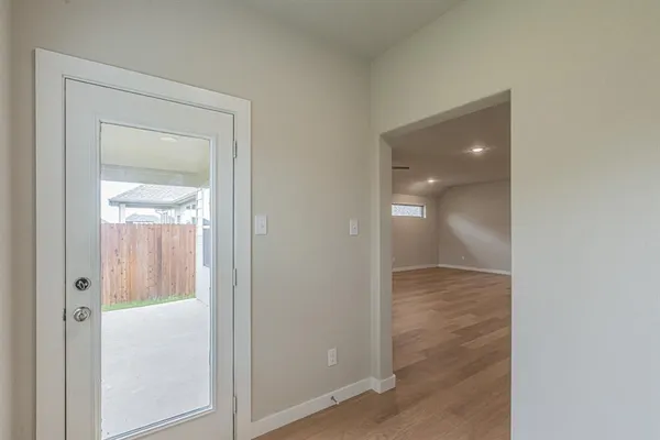 an empty room and closet with wooden floor