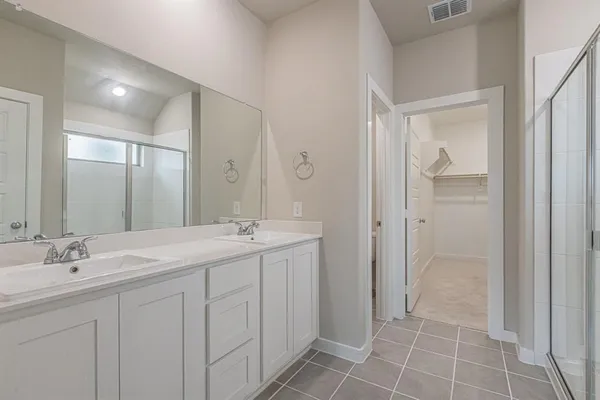 a bathroom with a double vanity sink and a mirror