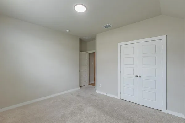 an empty room with closet area