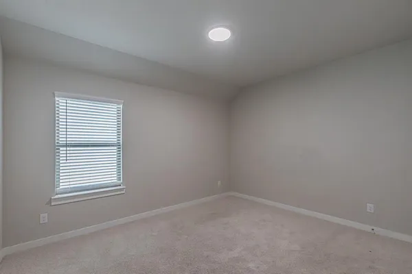 an empty room with closet area