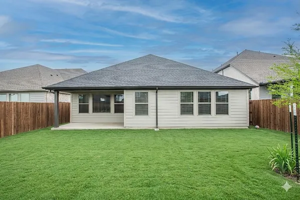 a view of a house with a backyard