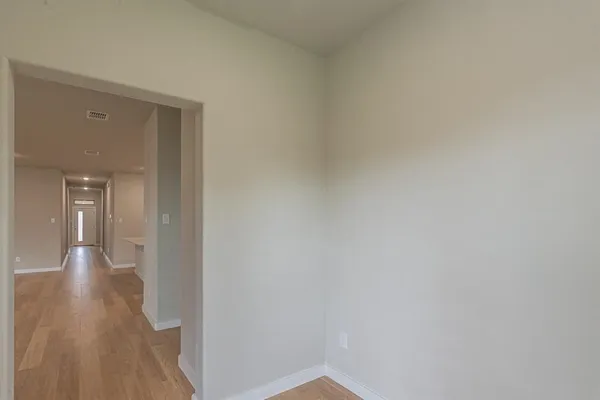 a view of a hallway with wooden floor