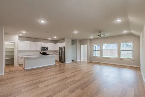 a view of kitchen with cabinets and wooden floor