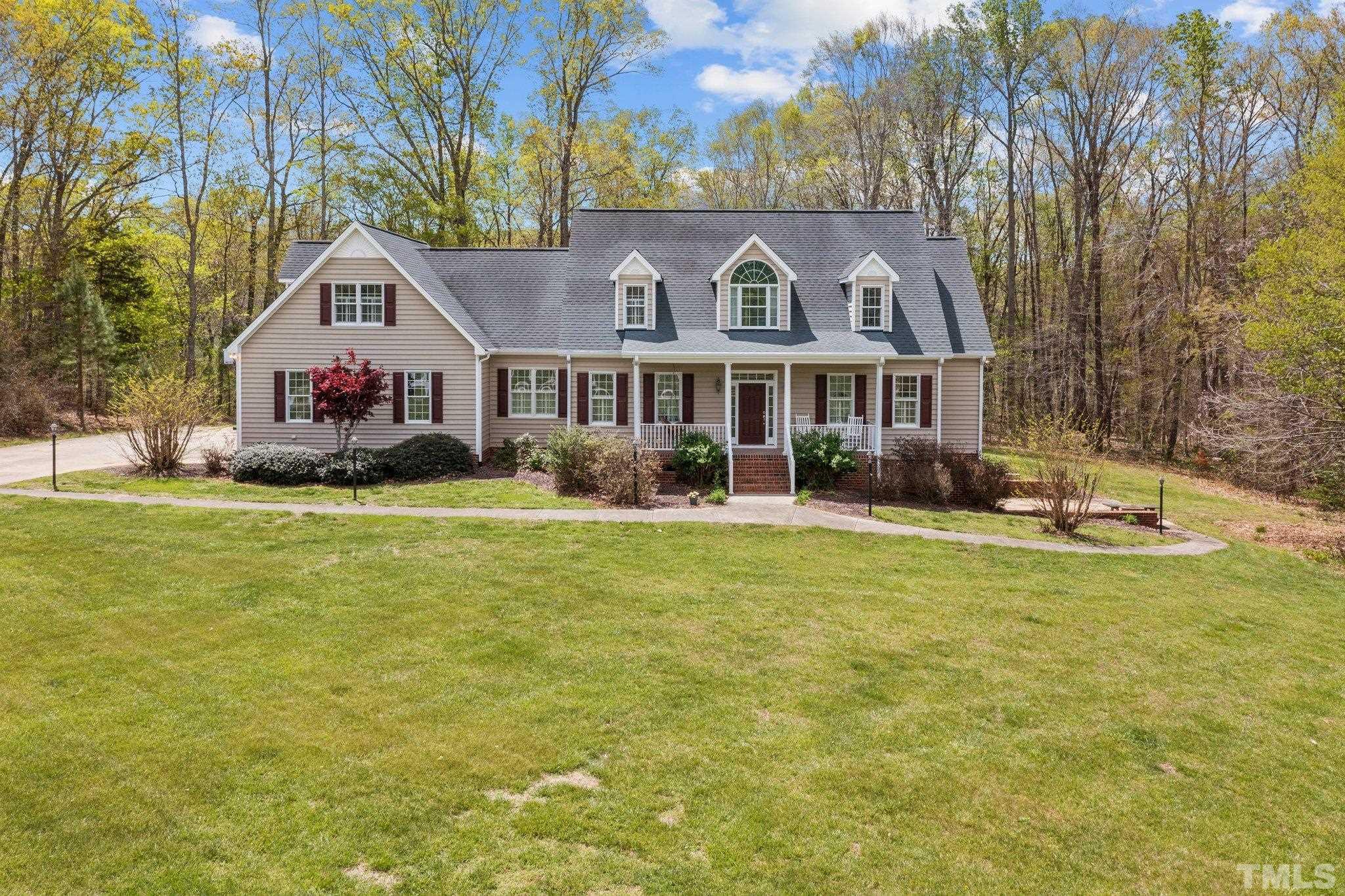 325 Onie Burton Road Rougemont, NC 27572 - Photo 1 of 39 a front view of a house with a yard table and chairs