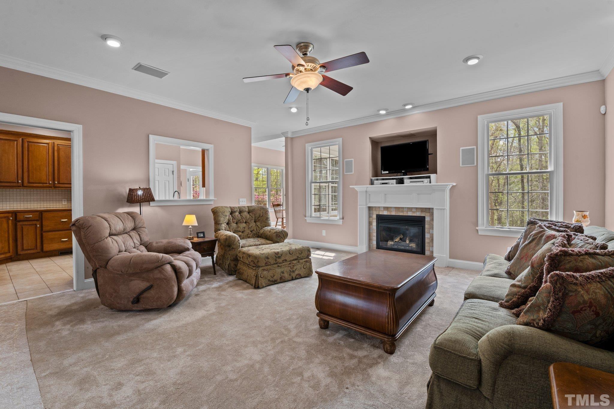 325 Onie Burton Road Rougemont, NC 27572 - Photo 10 of 39 a living room with furniture a flat screen tv and a fireplace