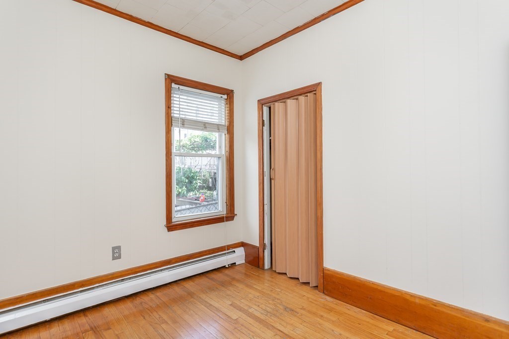 325 Hope Street Fall River, MA 02721 - Photo 13 of 34 a view of an empty room with window and wooden floor