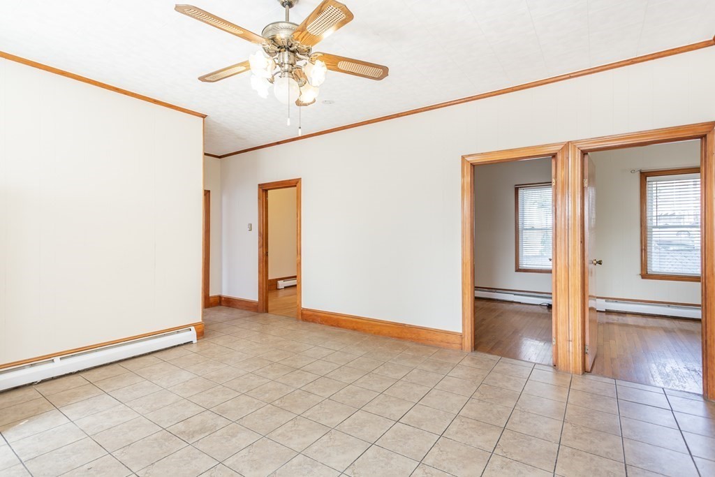 325 Hope Street Fall River, MA 02721 - Photo 5 of 34 an empty room with fan and a chandelier fan