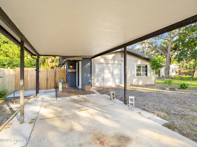 a bathroom with a tub and large windows