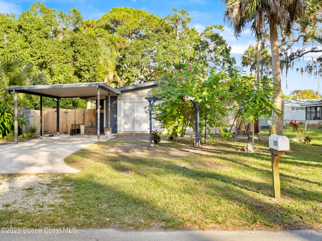 a view of a swimming pool with a lawn chairs under an umbrella