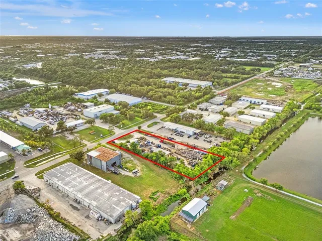 an aerial view of residential houses with outdoor space and swimming pool