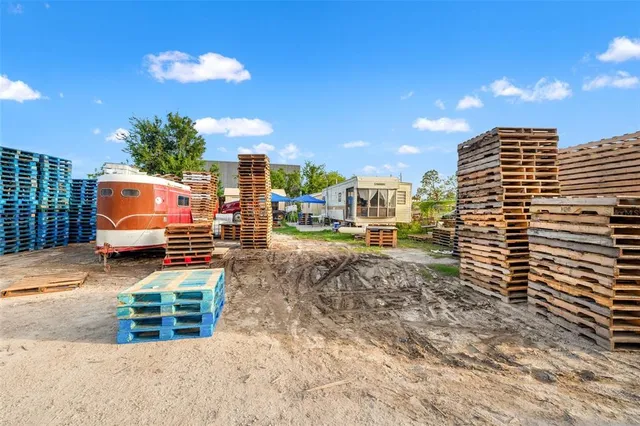 a view of a patio with table and chairs and potted plants