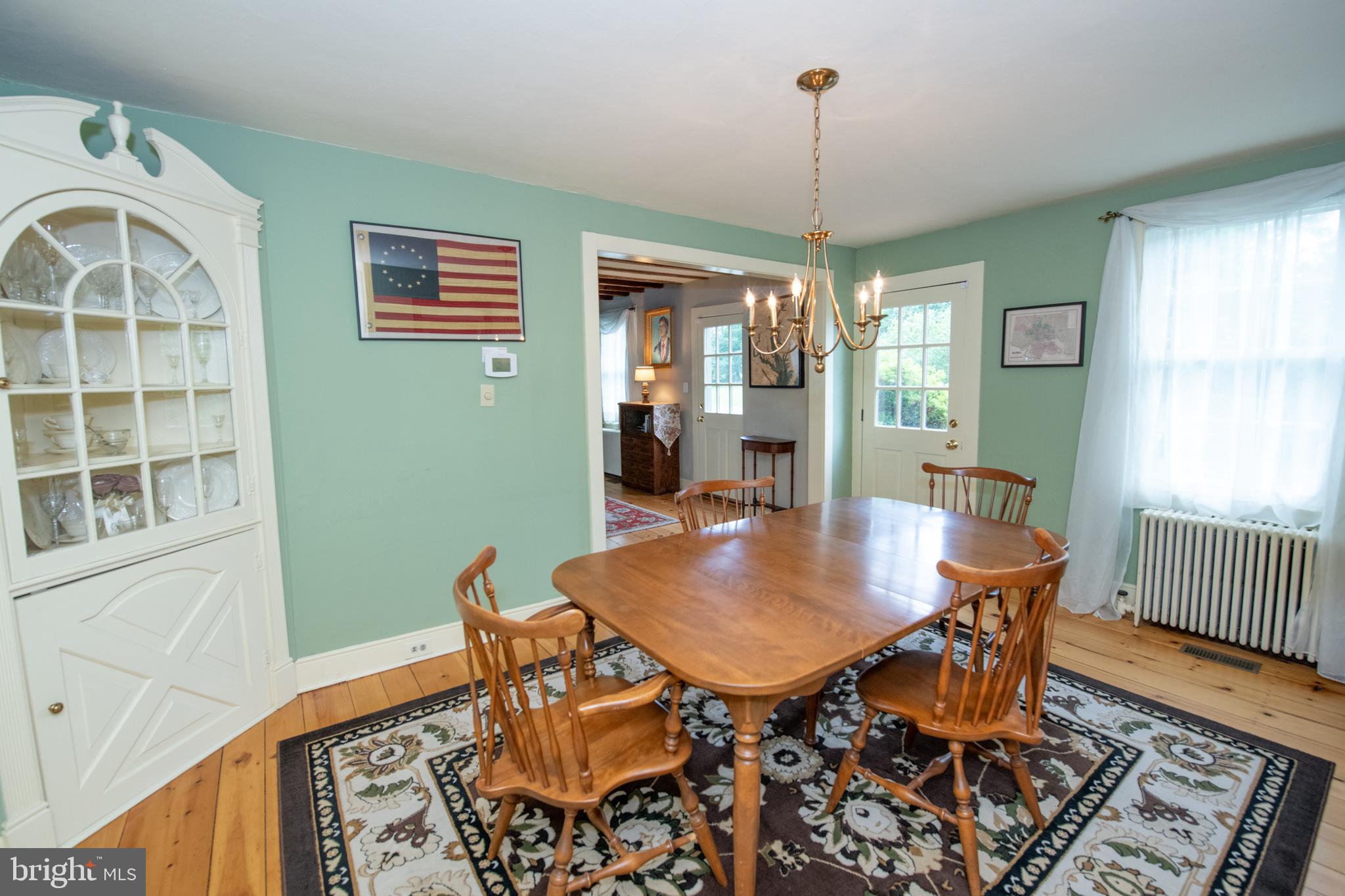 107 Stoopville Road Newtown, PA 18940 - Photo 17 of 60 a dining room with furniture a chandelier and wooden floor