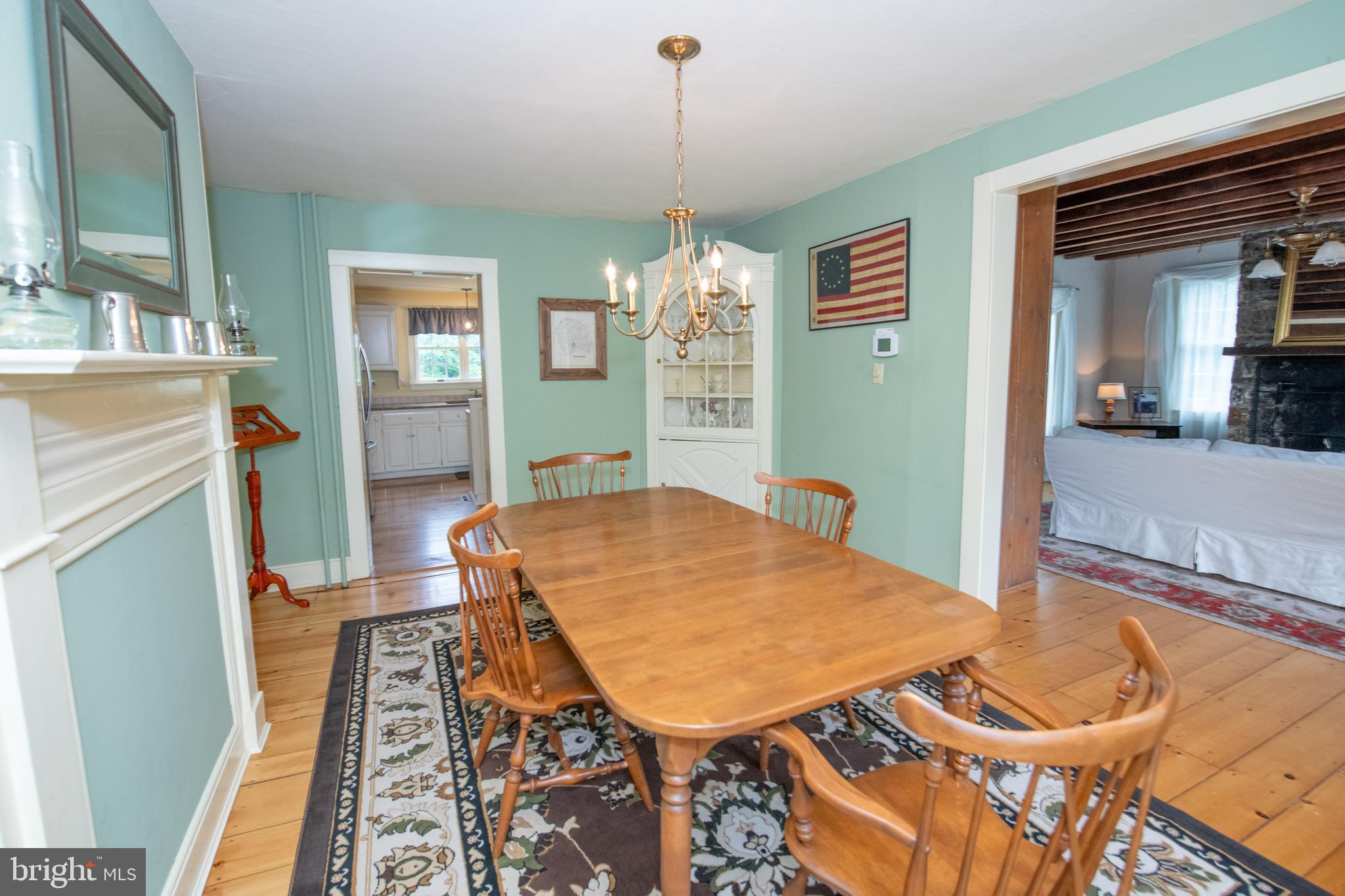 107 Stoopville Road Newtown, PA 18940 - Photo 21 of 60 a living room with furniture a dining table and a chandelier
