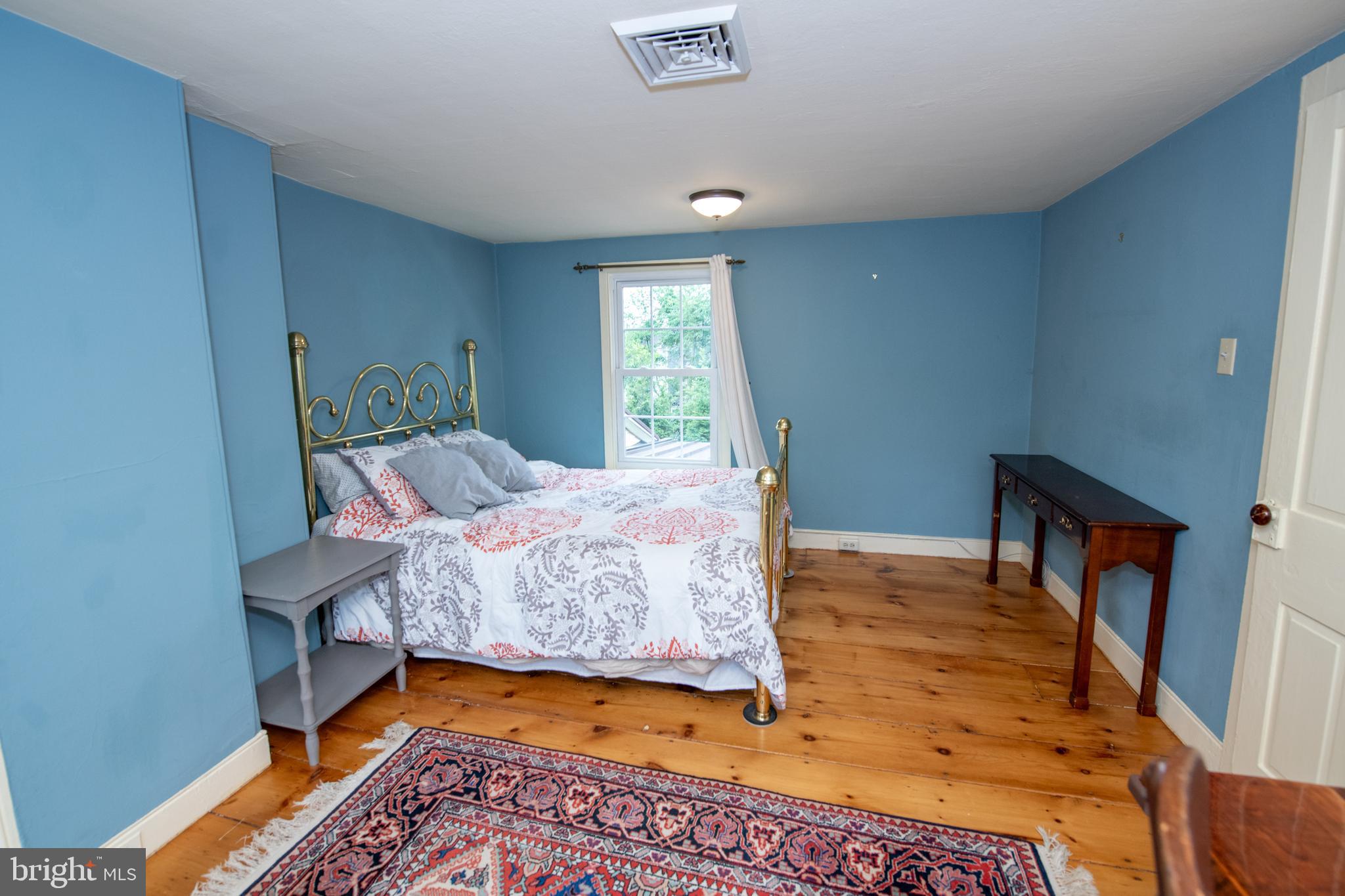 107 Stoopville Road Newtown, PA 18940 - Photo 30 of 60 a bedroom with a bed and wooden floor