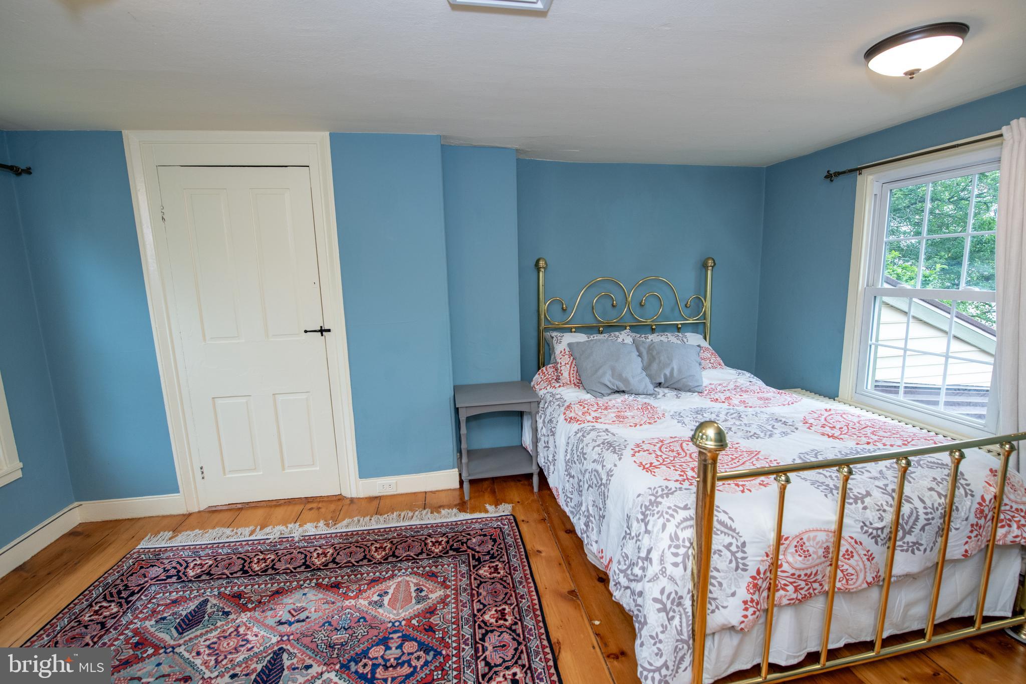 107 Stoopville Road Newtown, PA 18940 - Photo 31 of 60 a bedroom with a bed and wooden floor