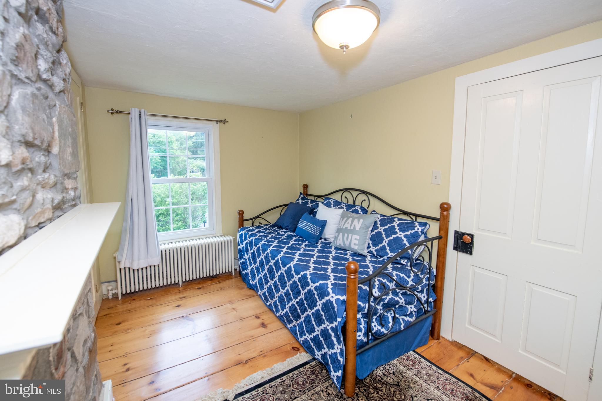 107 Stoopville Road Newtown, PA 18940 - Photo 33 of 60 a bedroom with bed and wooden floor