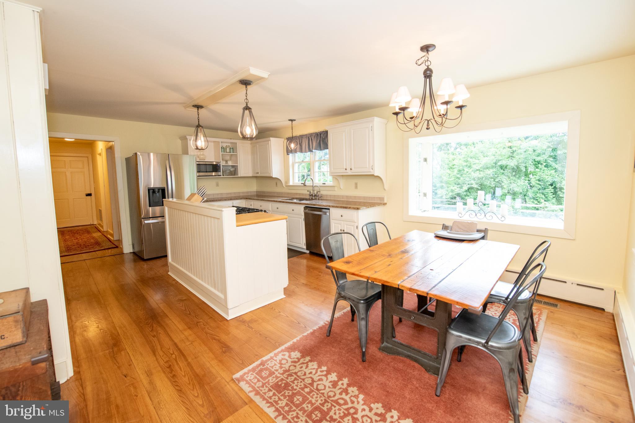 107 Stoopville Road Newtown, PA 18940 - Photo 7 of 60 a dining room with a table chairs and a kitchen view