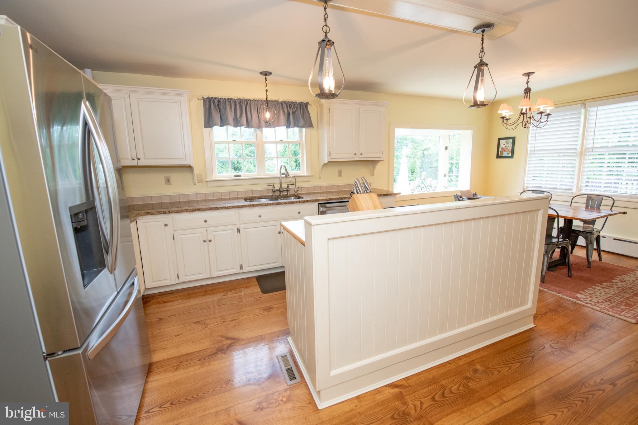 107 Stoopville Road Newtown, PA 18940 - Photo 8 of 60 a kitchen with stainless steel appliances granite countertop a refrigerator a sink a stove and white cabinets