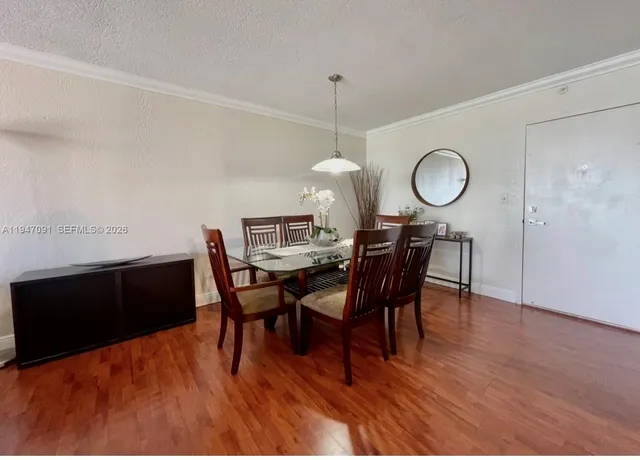a view of a dining room with furniture and wooden floor