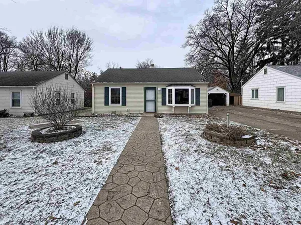 a house that has a tree in front of it