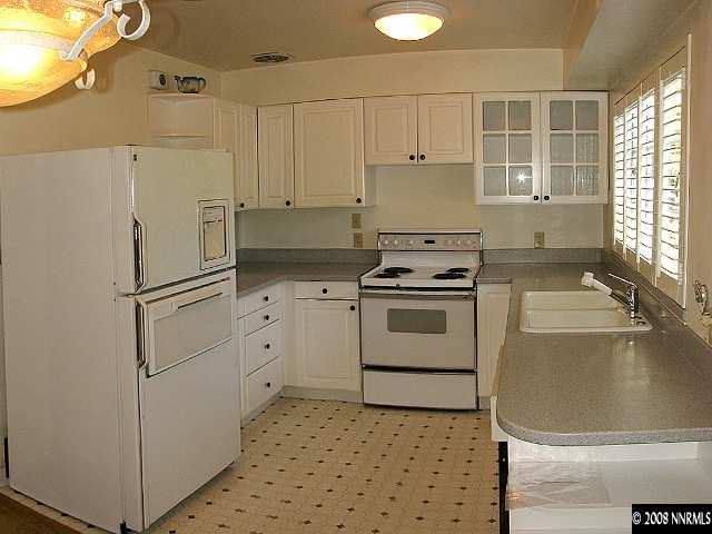 690 Georgia Place Reno, NV 89509 - Photo 3 of 9 a kitchen with white cabinets and white appliances