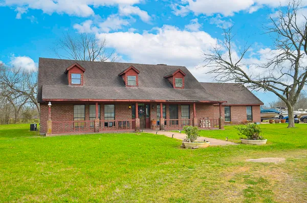 a view of a house with a yard porch and sitting area