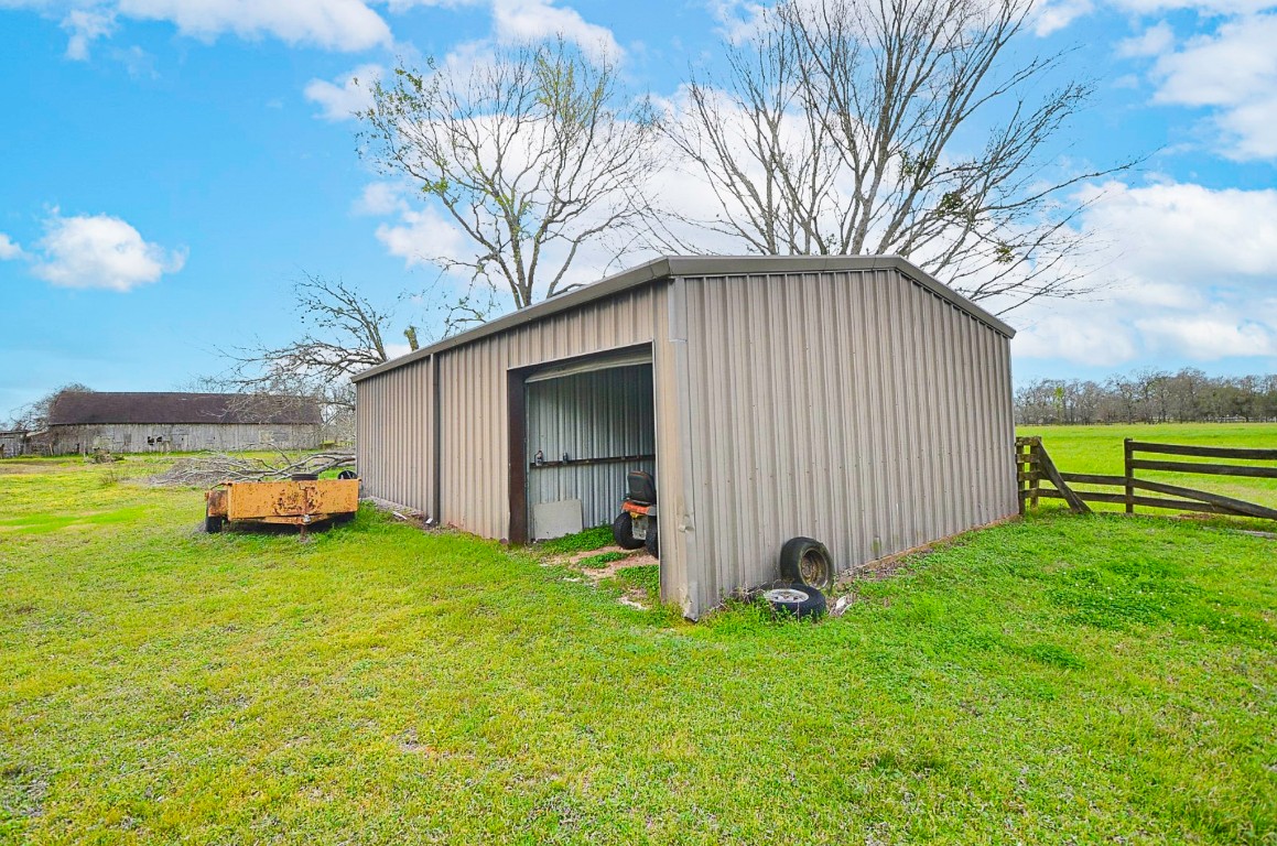 34520 Fulshear Farms Road Fulshear, TX 77441 - Photo 13 of 19 a view of a backyard with plants and a large tree