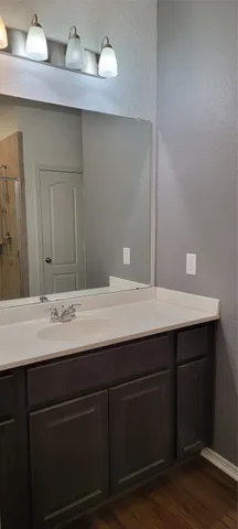 a bathroom with a glass shower door