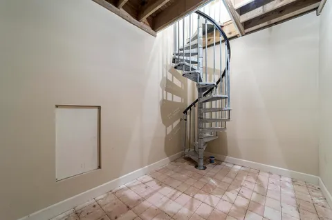 a view of staircase with lots of frames on wall and a view of entryway