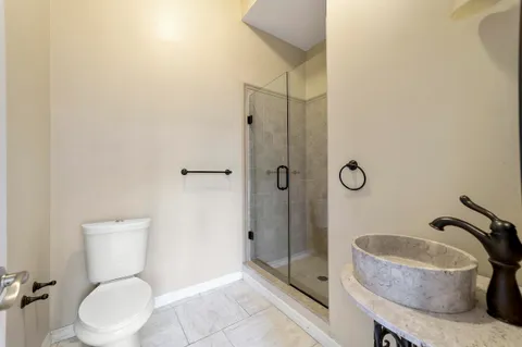 a spacious bathroom with a tub sink shower and mirror