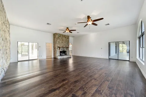 a view of a house with backyard and deck
