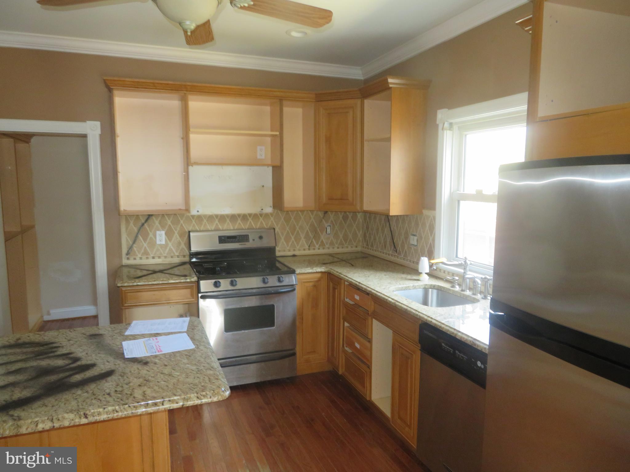 125 West Cottage Avenue Haddonfield, NJ 08033 - Photo 12 of 38 a kitchen with stainless steel appliances granite countertop a sink stove and refrigerator