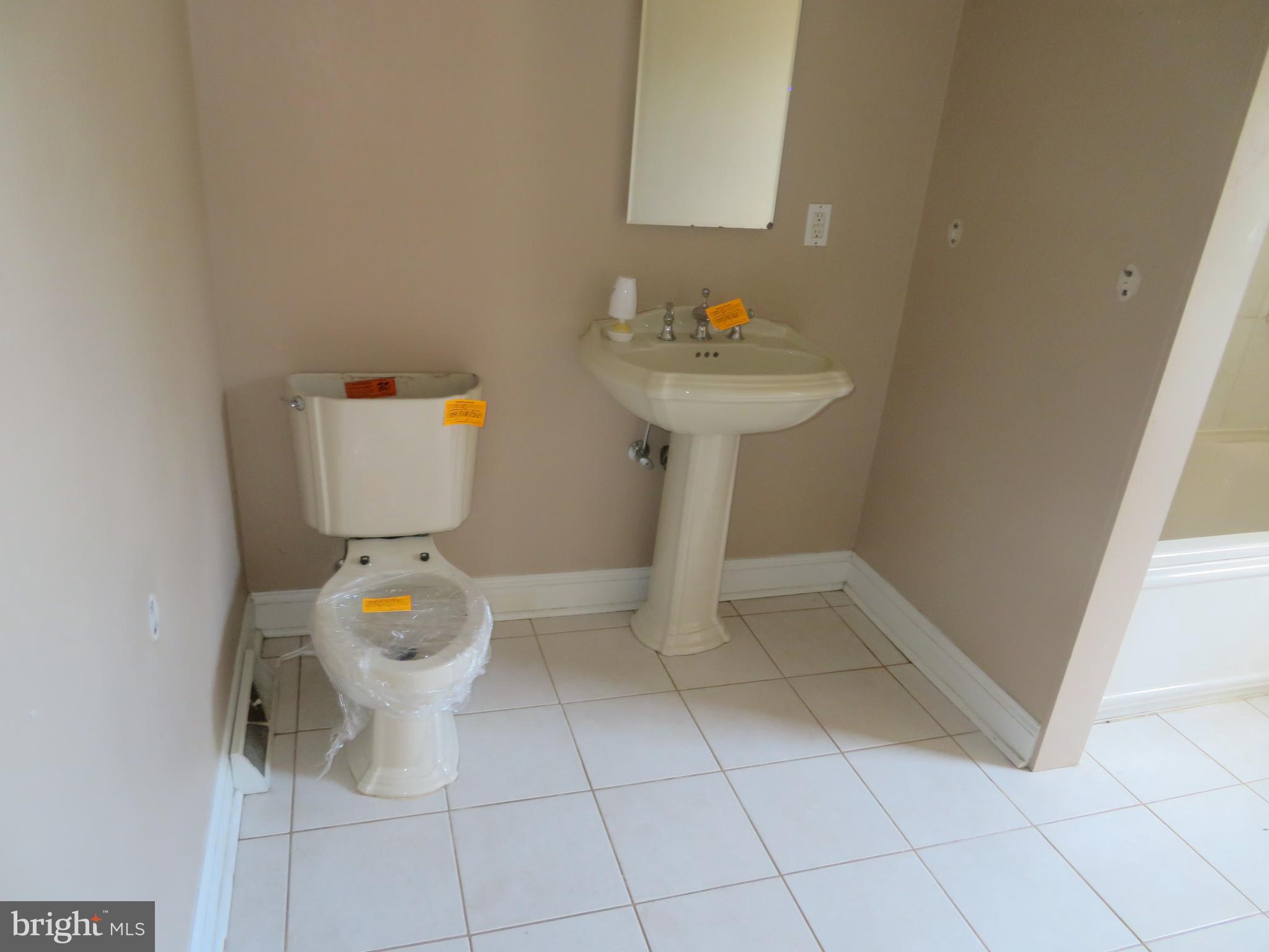 125 West Cottage Avenue Haddonfield, NJ 08033 - Photo 27 of 38 a bathroom with a sink toilet and a mirror