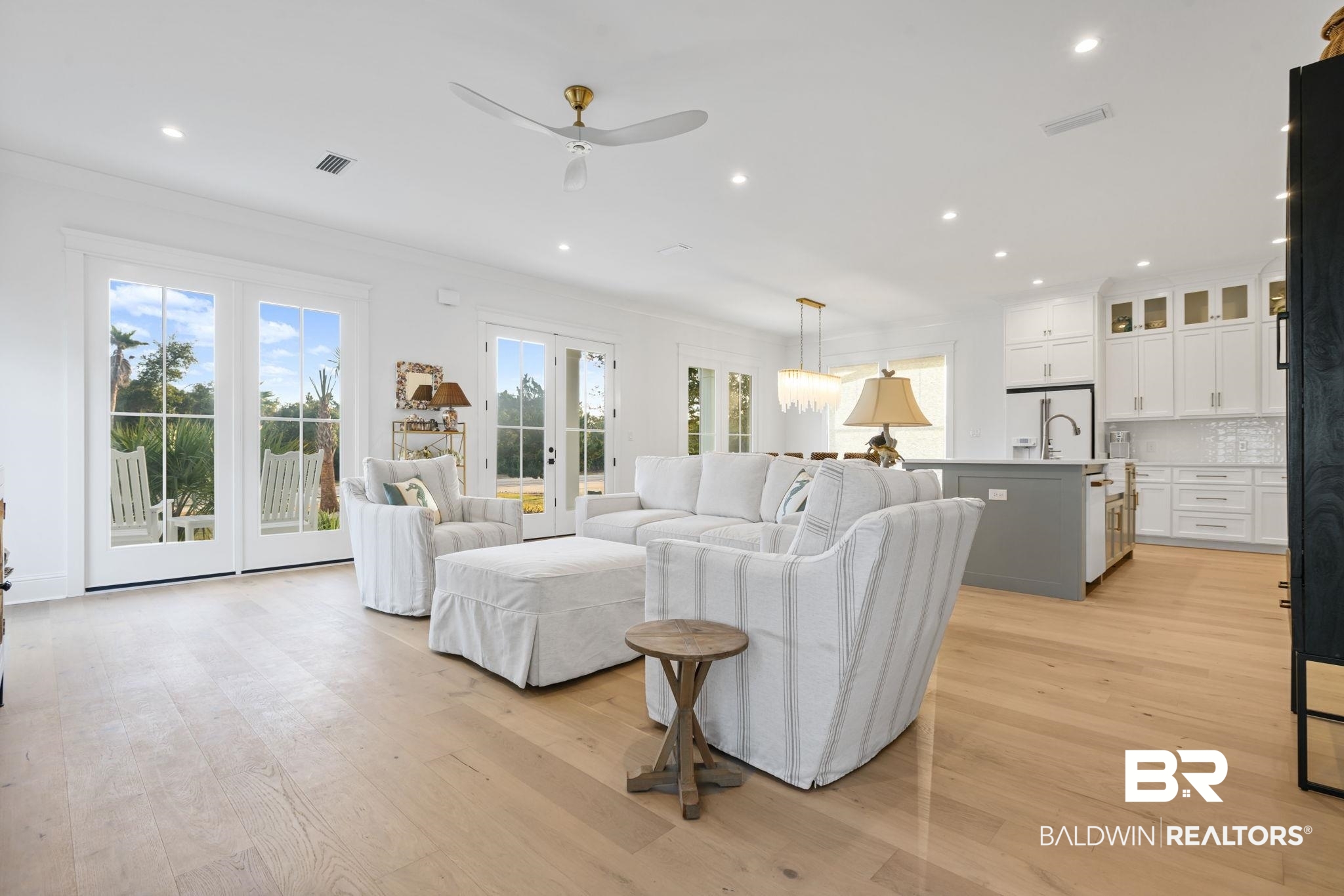 30313 River Road Orange Beach, AL 36561 - Photo 17 of 50 Living area featuring light wood-type flooring, french doors, a ceiling fan, recessed lighting, and ornamental molding