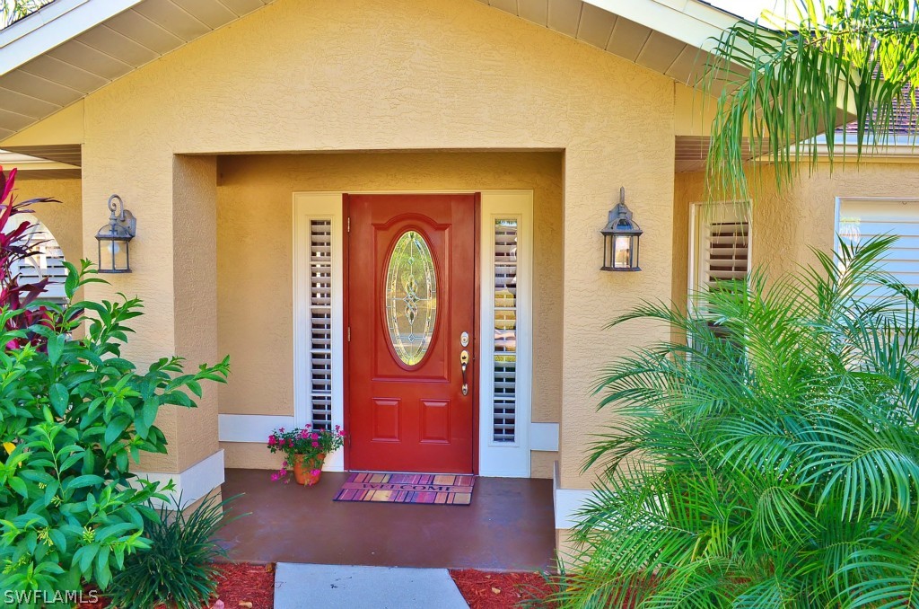 17432 Georgia Road Fort Myers, FL 33967 - Photo 1 of 20 a front view of a house with garden