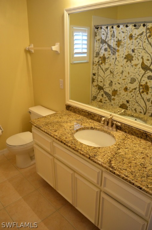 17432 Georgia Road Fort Myers, FL 33967 - Photo 15 of 20 a bathroom with a granite countertop sink a toilet and a shower