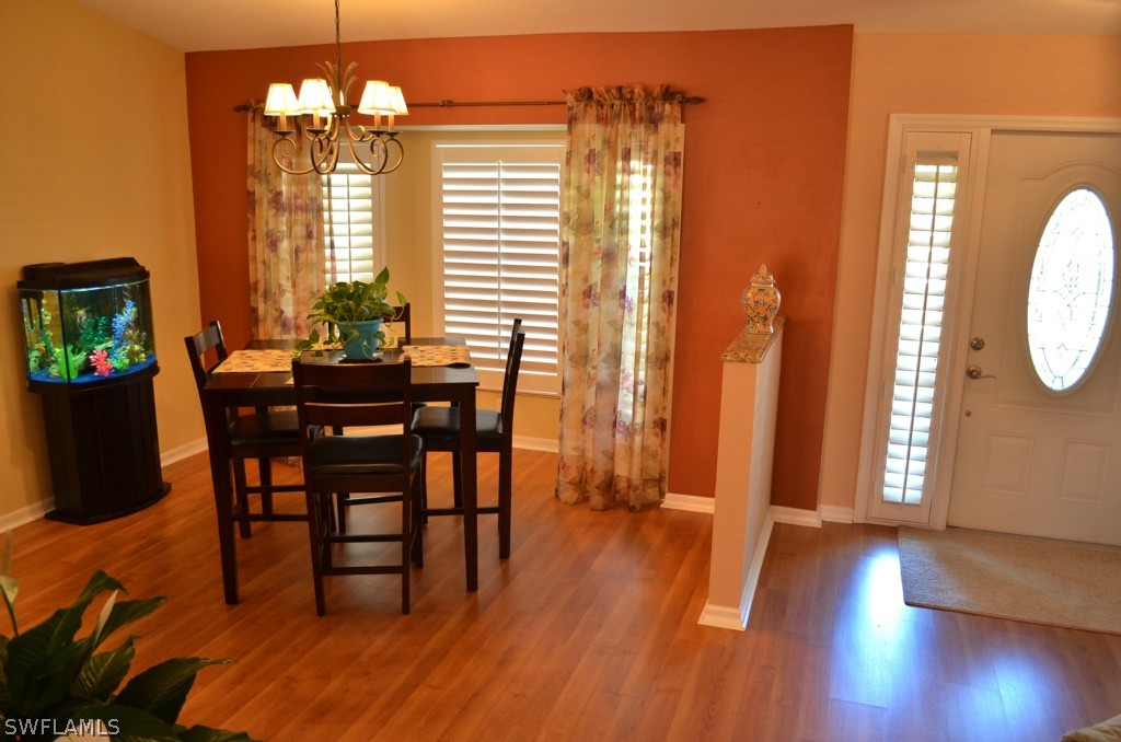 17432 Georgia Road Fort Myers, FL 33967 - Photo 3 of 20 a view of a dining room with furniture and wooden floor