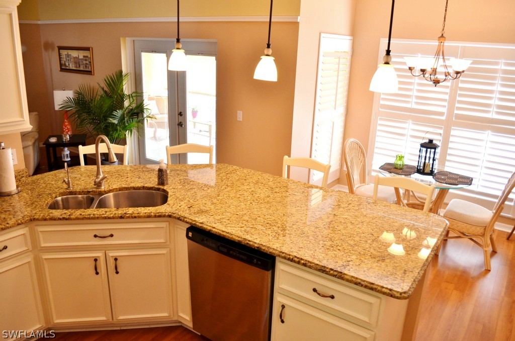 17432 Georgia Road Fort Myers, FL 33967 - Photo 9 of 20 a kitchen with stainless steel appliances granite countertop a sink a stove and a wooden cabinets