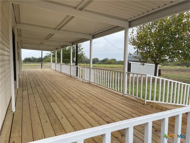 a view of balcony with wooden floor